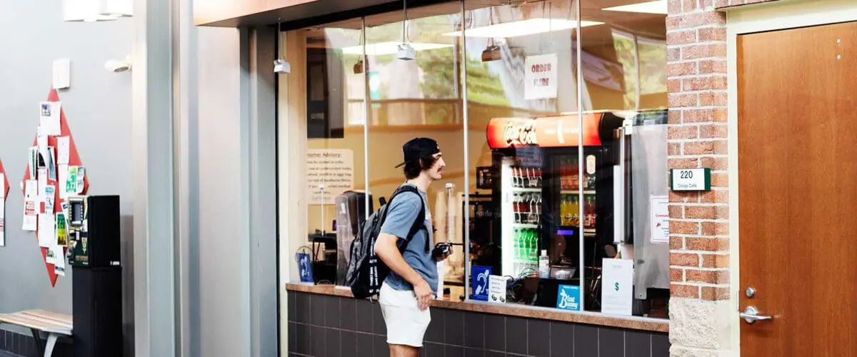 Student waiting to order at cafe window