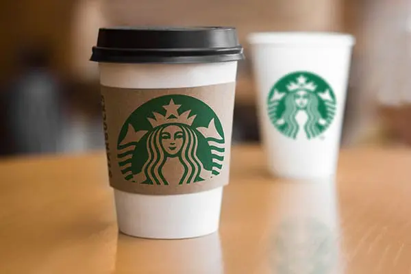 Starbucks paper cups on wood table
